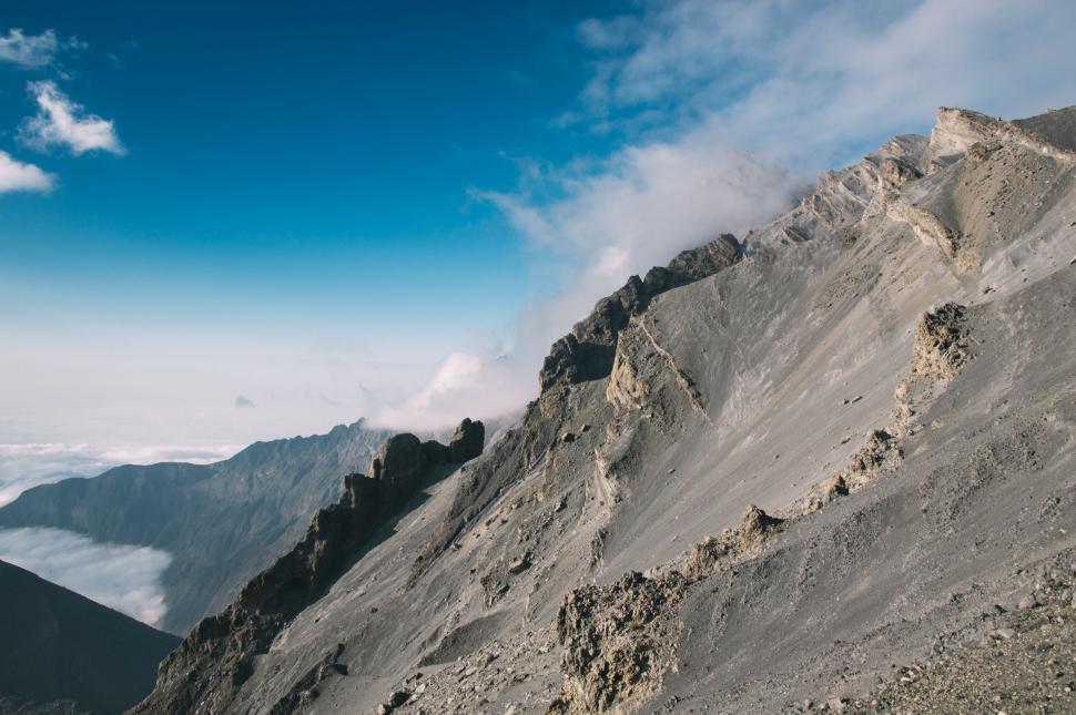 Free Image of Man Riding Snowboard Down Mountain 