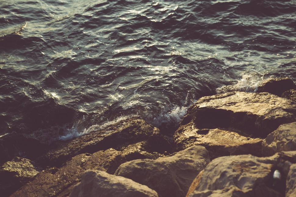 Free Image of Person Standing on Rocky Shore by Ocean 