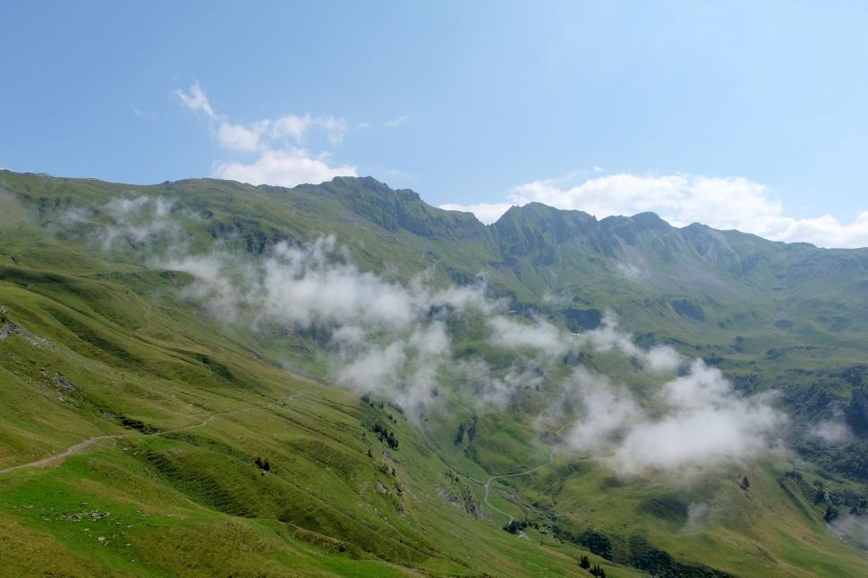 Free Image of Green Mountain With Few Clouds in the Sky 