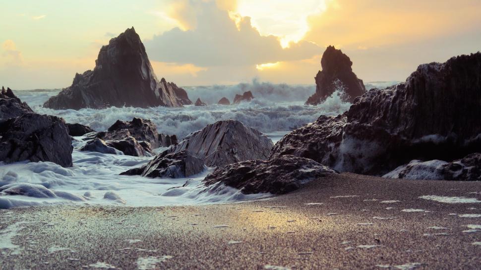 Free Image of Group of Rocks on Sandy Beach 