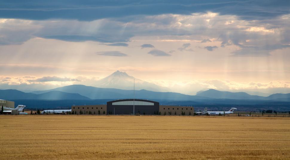 Free Image of Large Field of Grass With a Building in the Background 