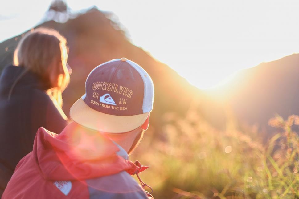 Free Image of Young Boy Wearing Hat Standing Next to Woman 