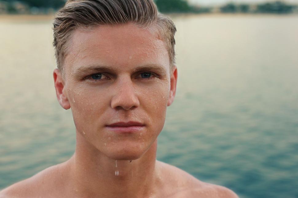 Free Image of Man Standing by Body of Water 