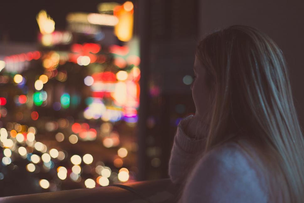 Free Image of Woman Gazing Over Night Cityscape 