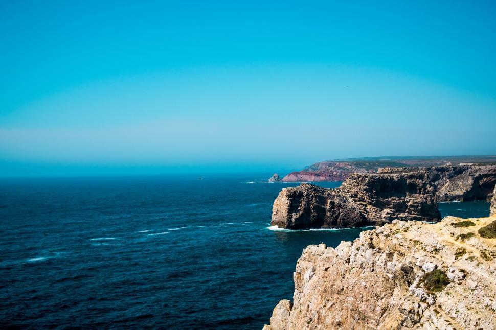 Free Image of Person Standing on Cliff Overlooking Ocean 