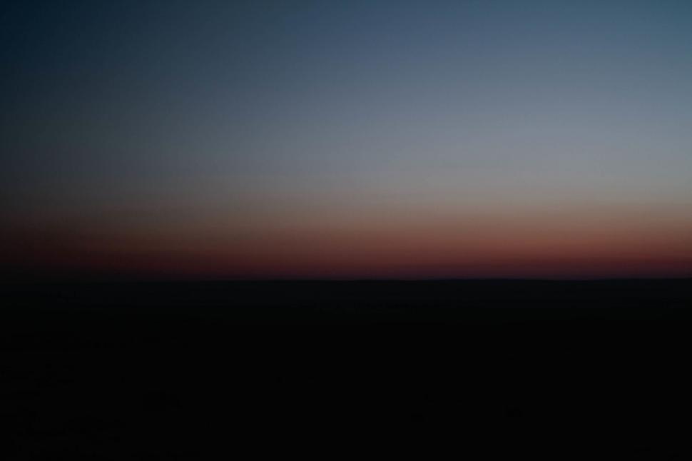 Free Image of A Plane Flying in the Sky at Dusk 