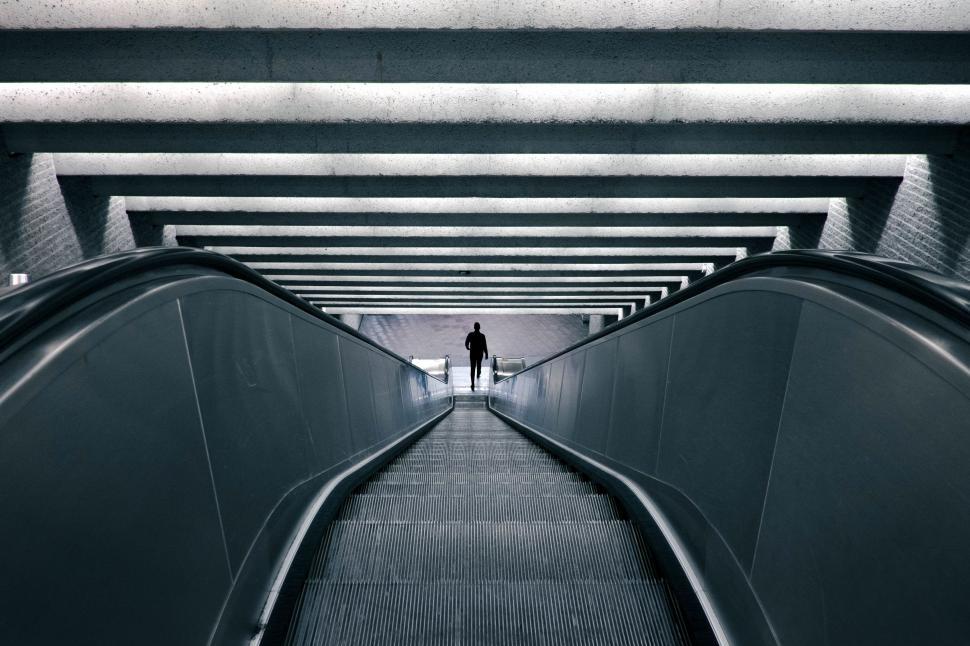 Free Image of Person Walking Down Escalator 