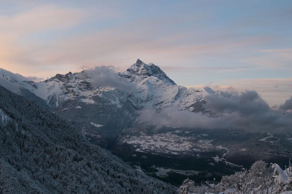 Free Image of Majestic Snow Covered Mountain Range With Clouds in the Sky 