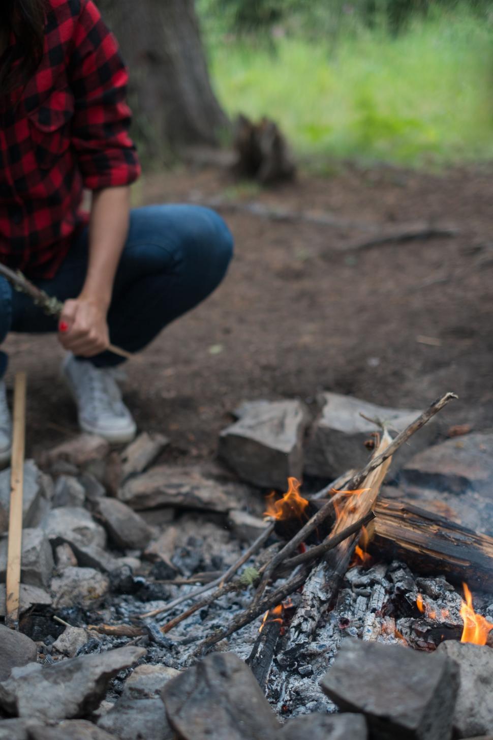 Free Image of Woman Cooking Food Over an Open Fire 