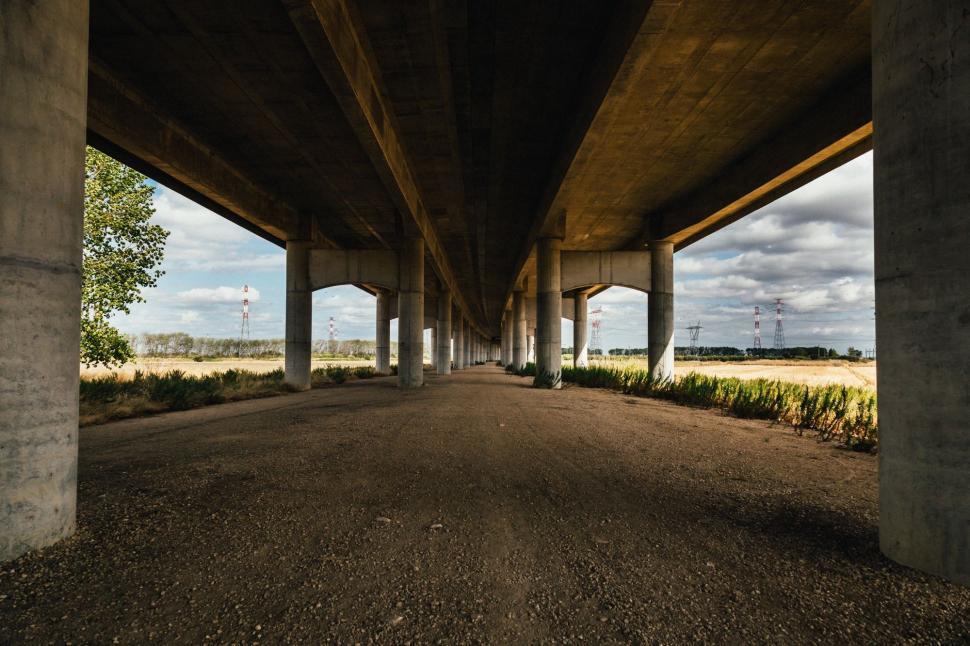 Free Image of Empty Road Under Bridge With Sky Background 