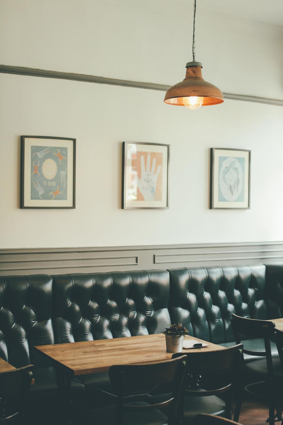 Free Image of Black Leather Couch Beside Wooden Table 