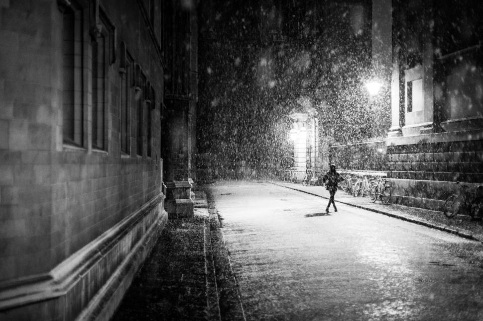 Free Image of Person Walking Down a Street at Night 