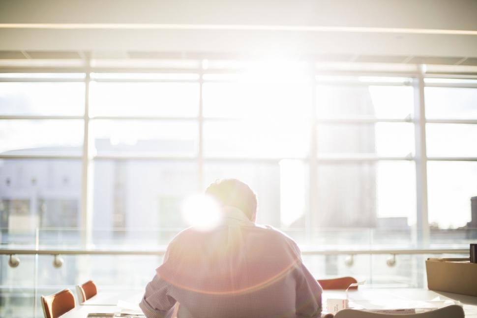Free Image of Man Sitting at Table by Window 