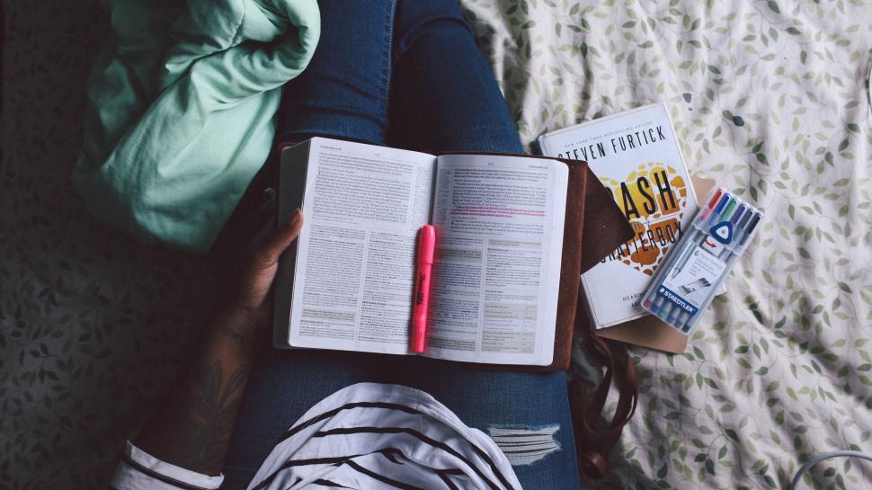 Free Image of Person Reading Book While Laying on Bed 