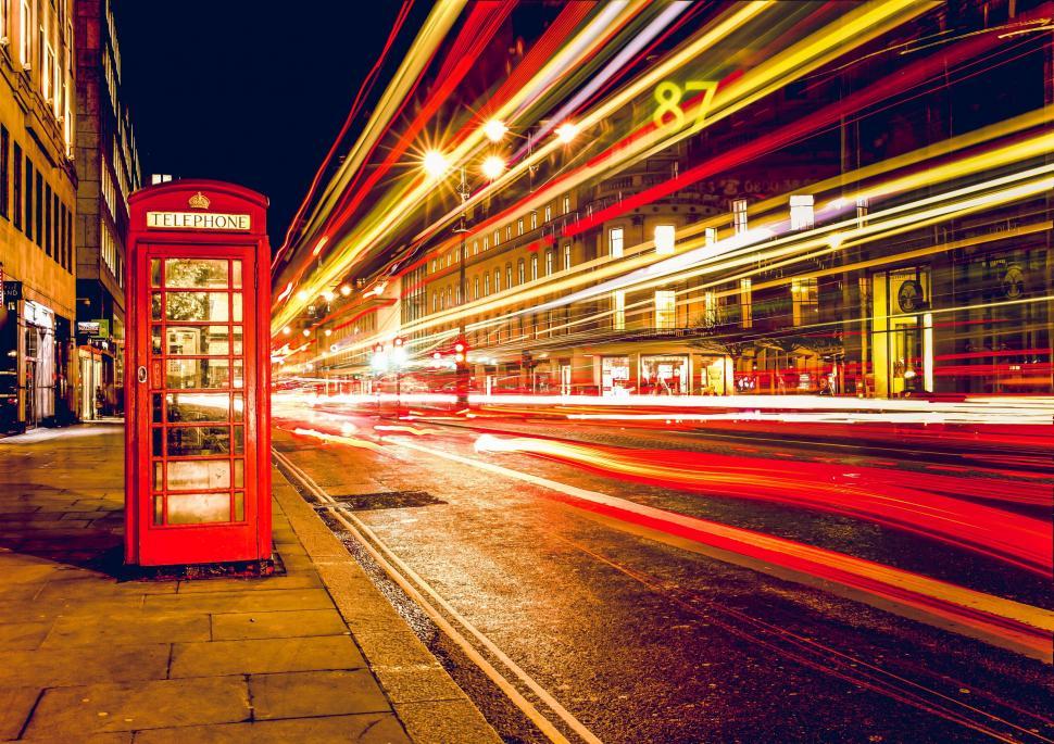 Free Image of Red Phone Booth Alongside Road 