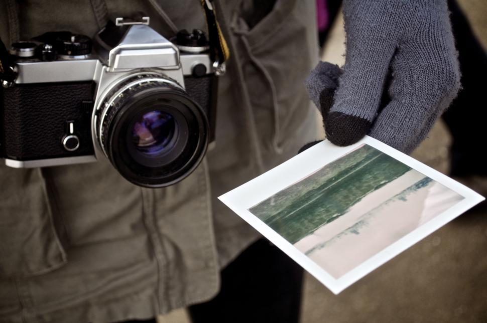 Free Image of Person Holding Camera and Picture 