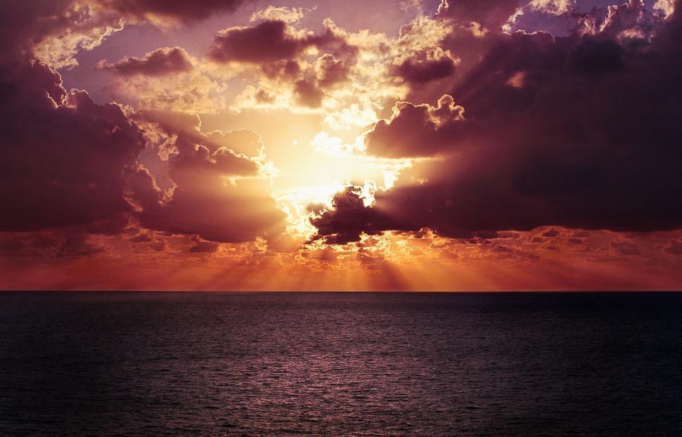 Free Image of Large Body of Water Under Cloudy Sky 