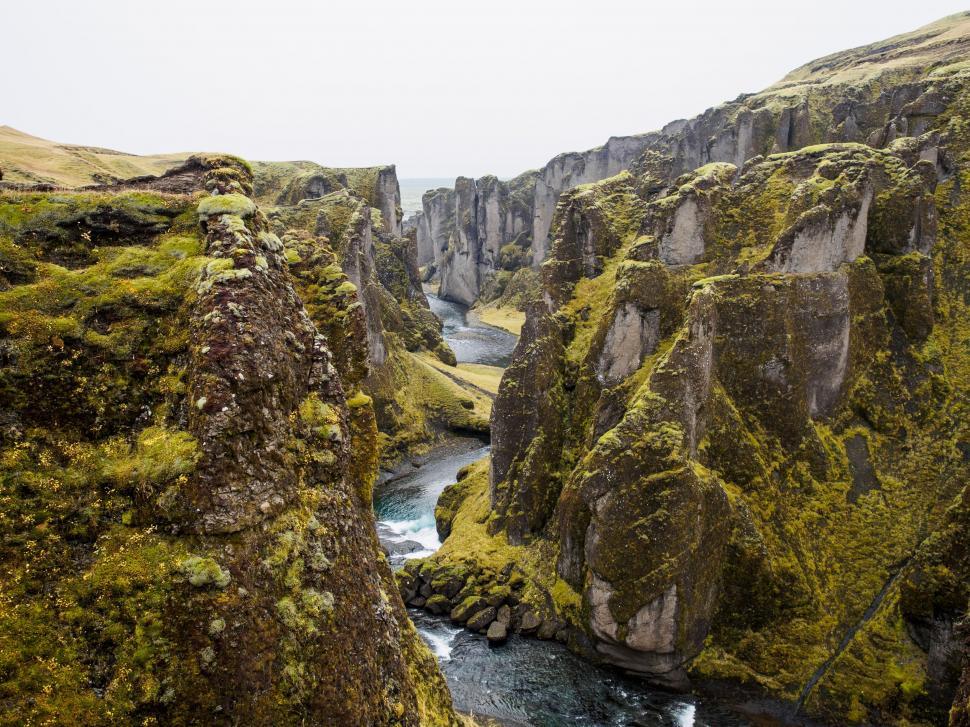 Free Image of River Flowing Through Lush Green Valley 
