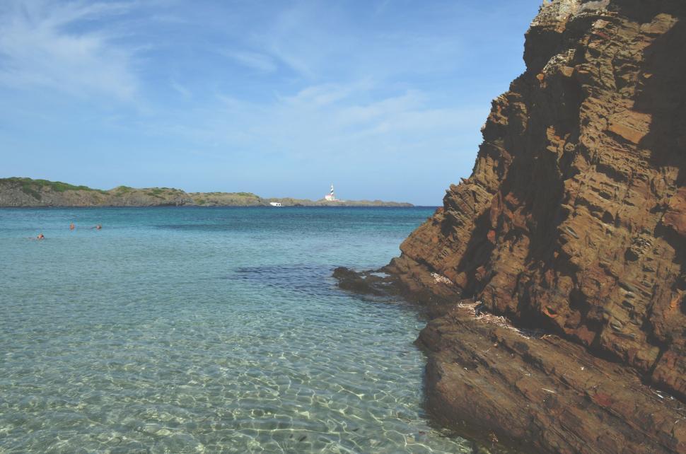 Free Image of Water Body Adjacent to Rocky Cliff 