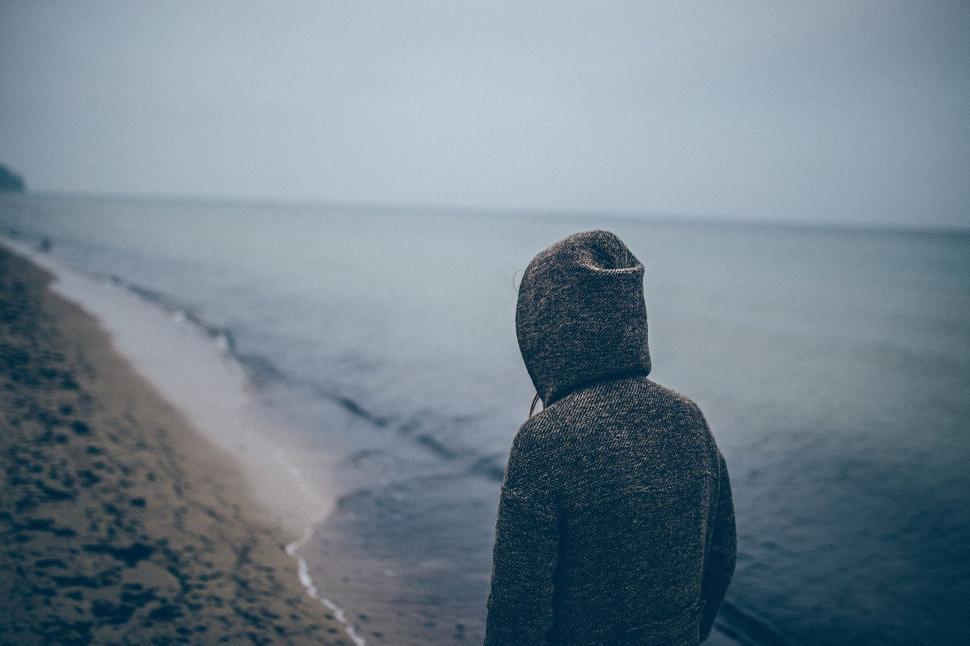 Free Image of Person Standing on Beach, Looking at Ocean 