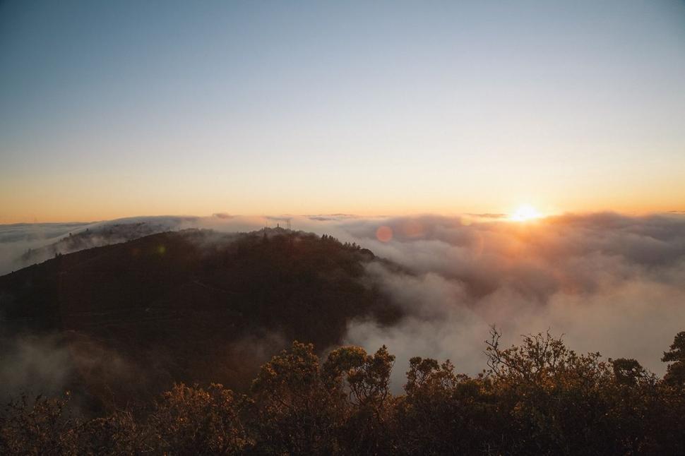 Free Image of Sun Setting Over Clouds in the Mountains 