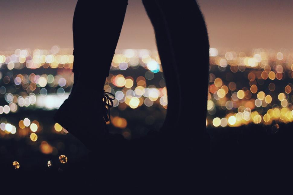 Free Image of Person Standing on Hill Overlooking City at Night 