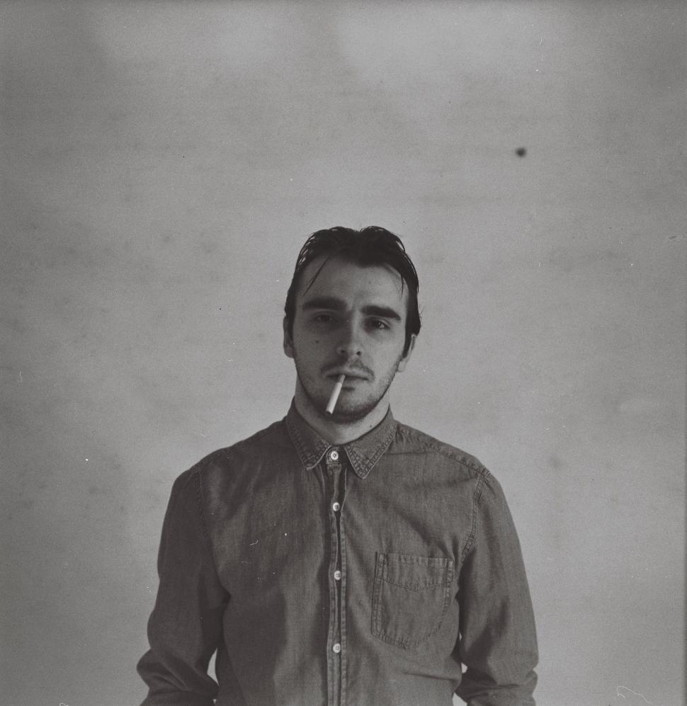 Free Image of Man Smoking Cigarette in Black and White 
