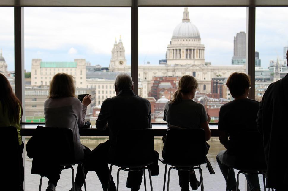 Free Image of Group of People Sitting in Front of Window 