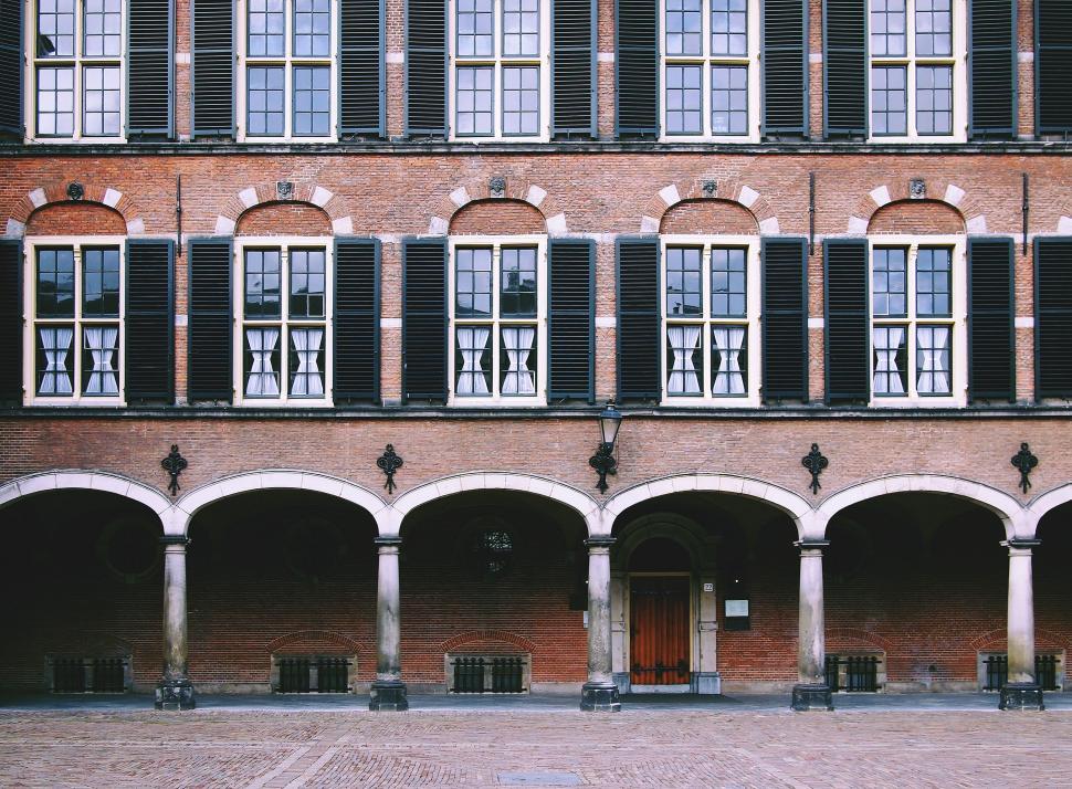 Free Image of Brick Building With Many Windows and Arches 