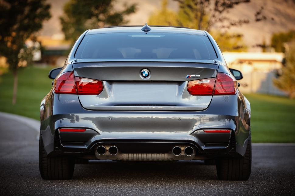 Free Image of Back End of Silver Car Parked in Driveway 