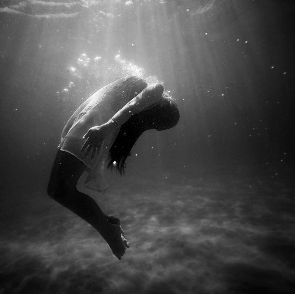 Free Image of Person Floating in Water With Head Above Surface 
