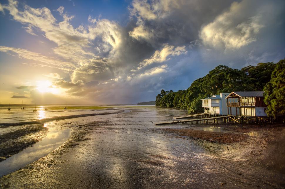Free Image of Sun Setting Over Water at Beach 