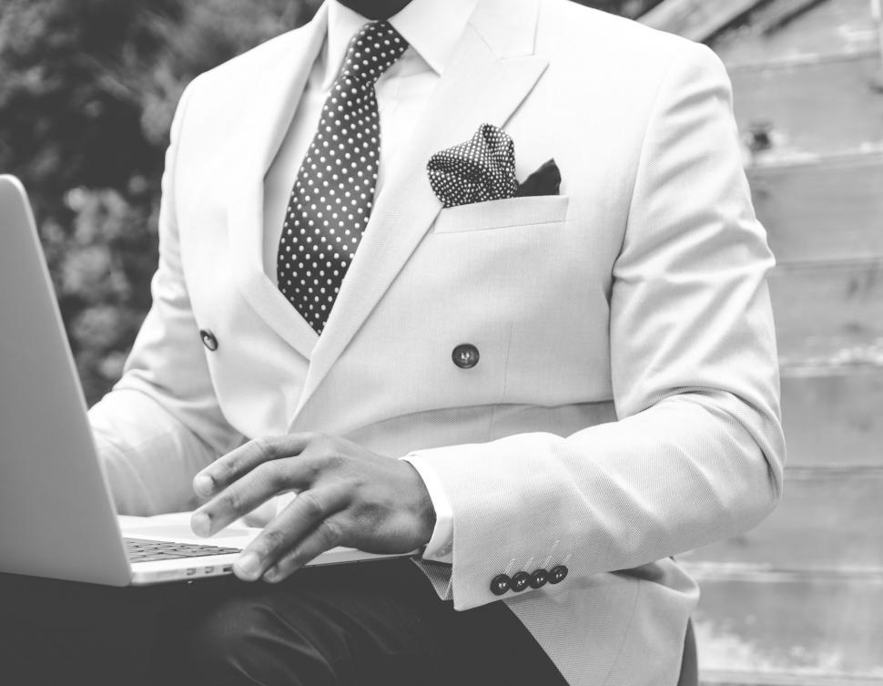 Free Image of Businessman in Suit and Tie Working on Laptop 