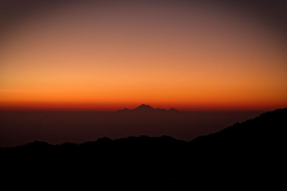 Free Image of Sun Setting Over Mountain Range 
