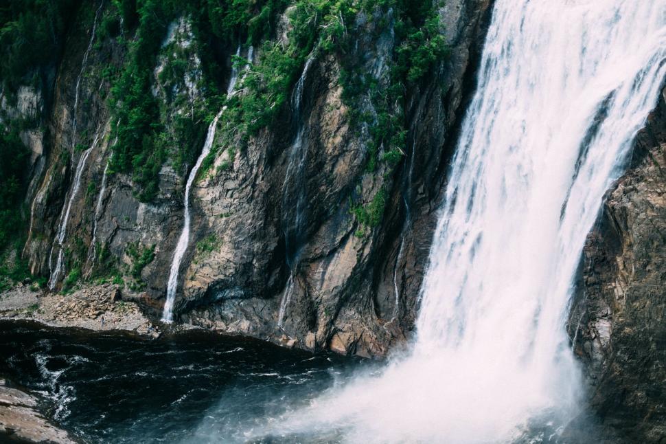 Free Image of Man Standing in Front of Waterfall 