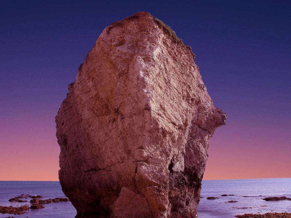 Free Image of Large Rock on Sandy Beach 