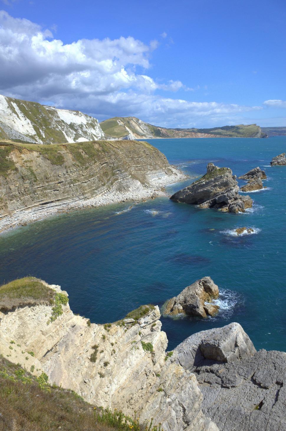 Free Image of Large Body of Water Surrounded by Rocks 