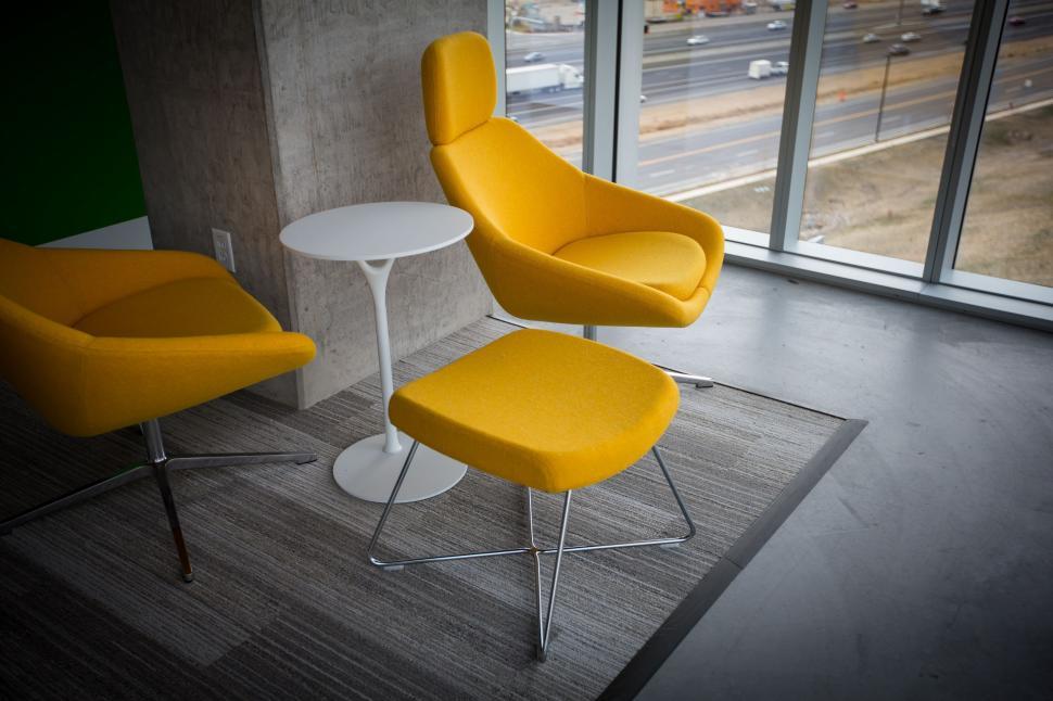 Free Image of Two Yellow Chairs and a White Table in a Room 