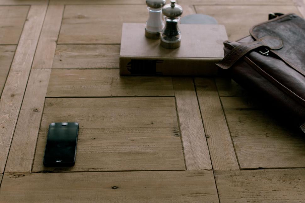 Free Image of Suitcase and Cell Phone on Table 