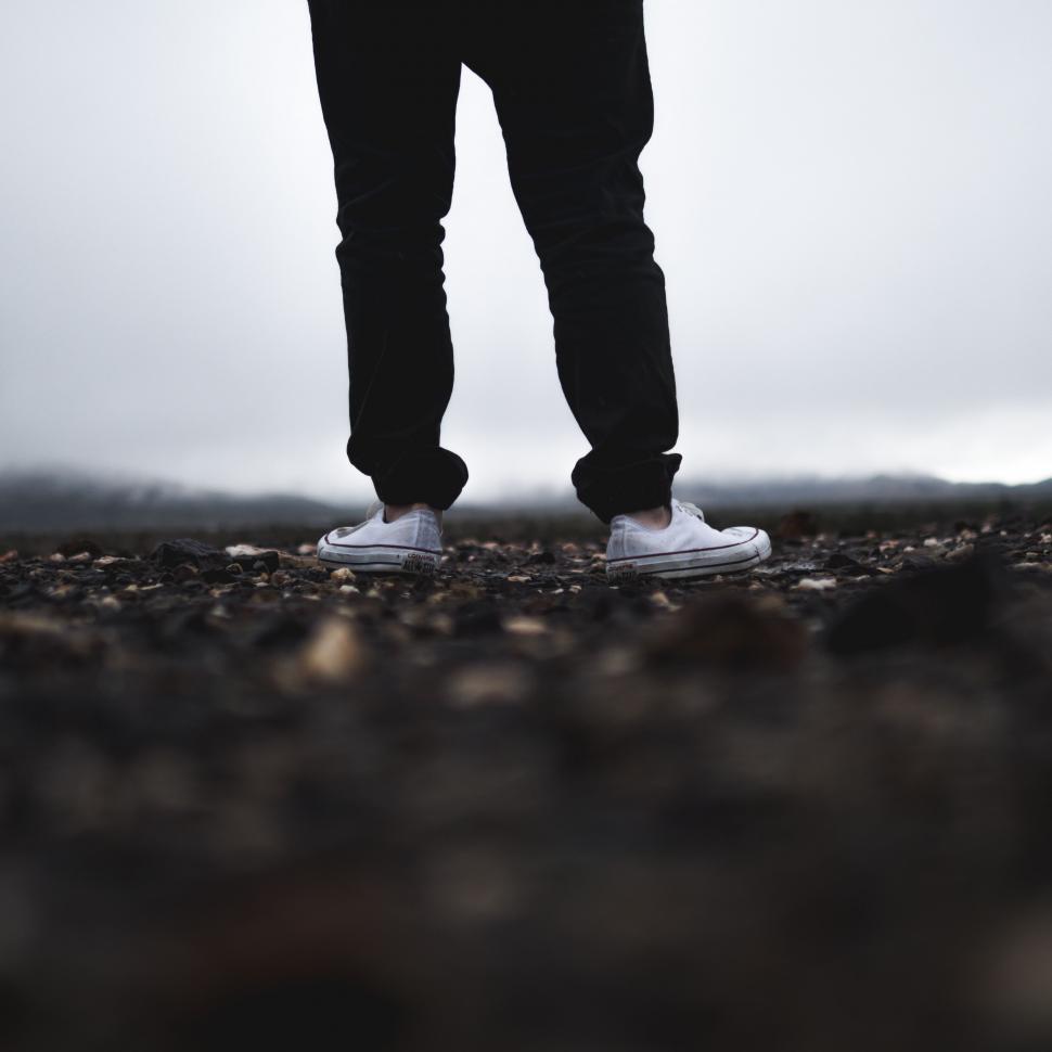 Free Image of Person Standing in Field With Hands in Pockets 