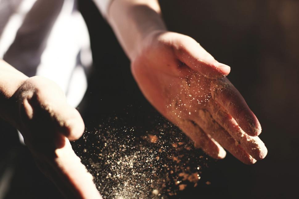 Free Image of Person Holding Hands Over Pile of Dirt 
