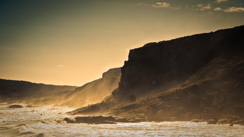 Free Image of Man Riding Surfboard on Wave-Covered Beach 