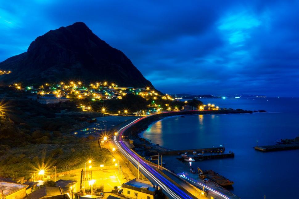 Free Image of Night Time Cityscape With Mountain in Background 