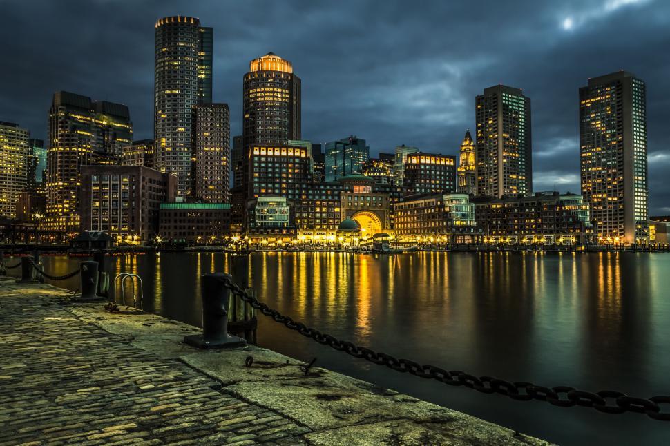 Free Image of City Skyline at Night With Lights Reflecting in Water 