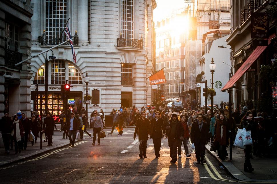 Free Image of Group of People Walking Down a City Street 