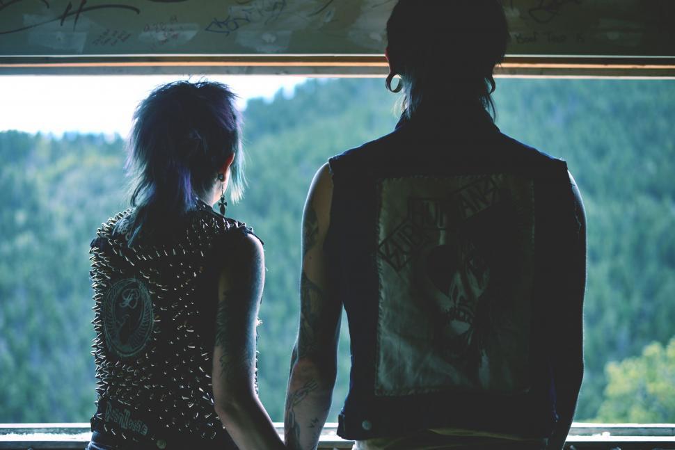 Free Image of Man and Woman Standing in Front of Window 