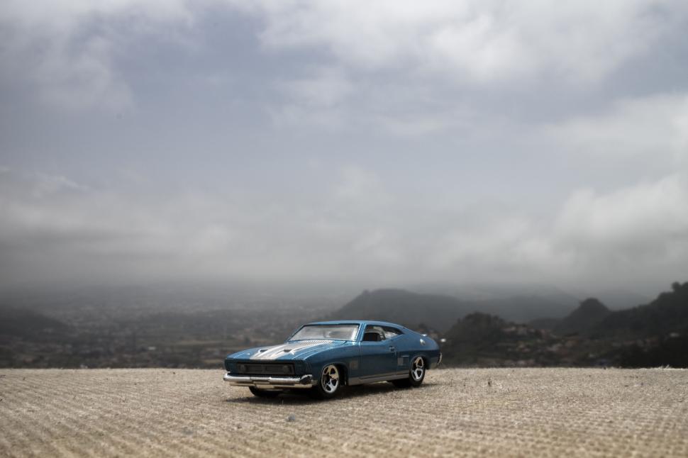 Free Image of Car Parked on Dirt Road in Field 