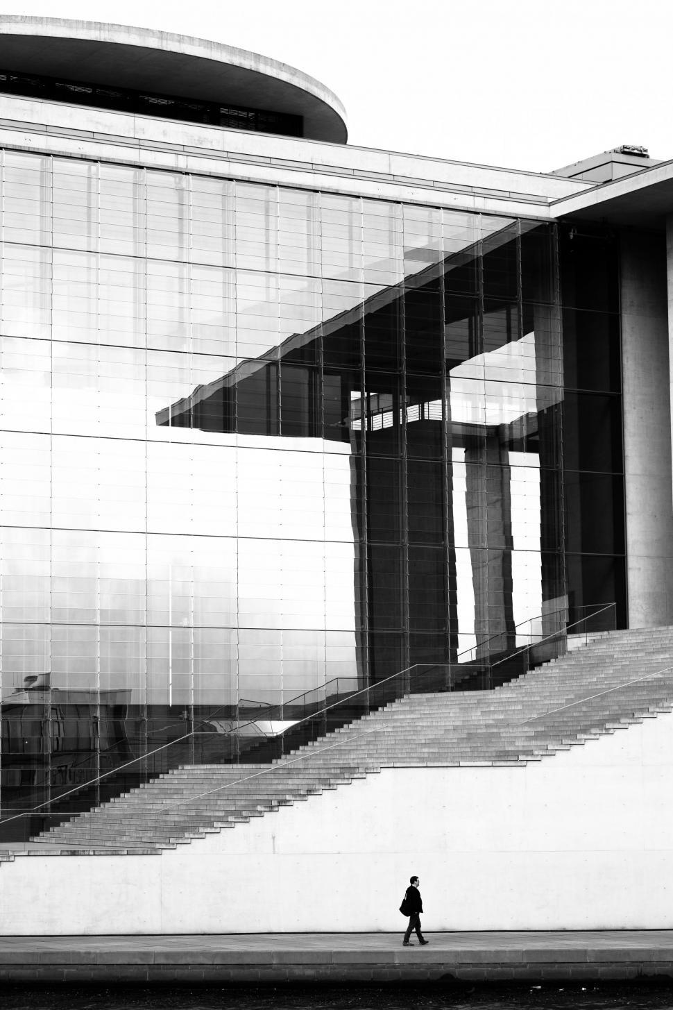 Free Image of Man Walking Past a Building 