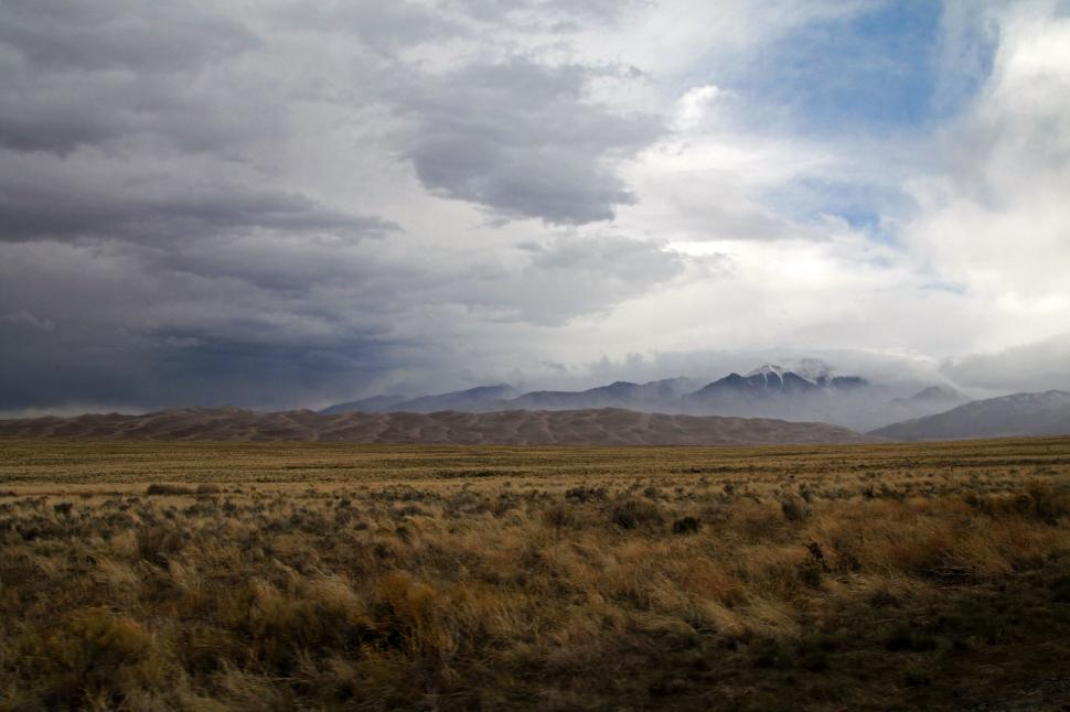 Free Image of Open Field With Mountains in Background 