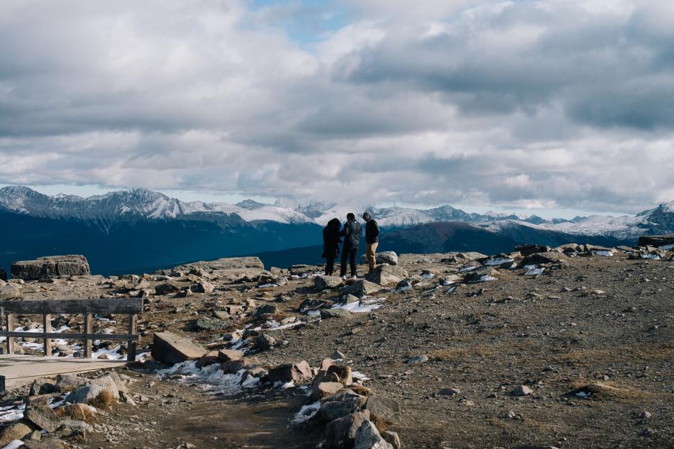 Free Image of Group of People Standing on Top of a Mountain 